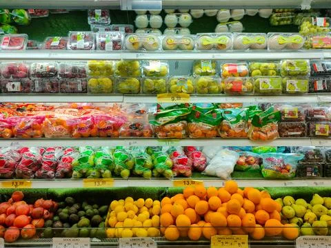 Various types of fresh fruit placed in a cold area in a supermarket Stock Photos
