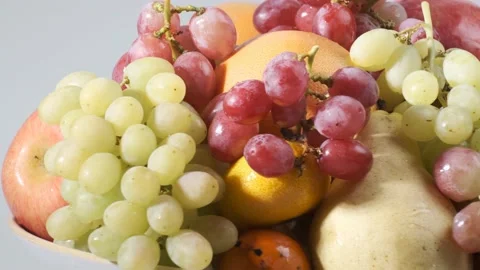 Various types of fresh fruits on white plate rotating in front of camera 스톡 동영상 167521086