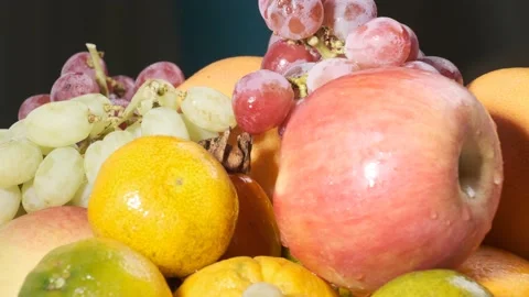 Various types of fresh fruits on white plate rotating in front of camera Stock-Footage 167521692