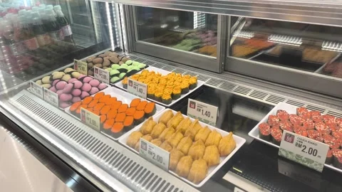 Various Types of Fresh Sushi Displayed for Sale Behind Glass Stock Footage 321040039