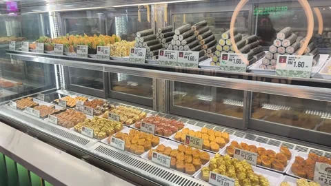 Various Types of Fresh Sushi Displayed for Sale Behind Glass Stock Footage 321040048