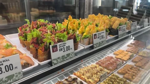 Various Types of Fresh Sushi Displayed for Sale Behind Glass Stock Footage 321040061
