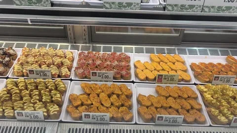 Various Types of Fresh Sushi Displayed for Sale Behind Glass Stock Footage 321040062
