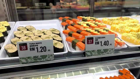 Various Types of Fresh Sushi Displayed for Sale Behind Glass Stock Footage 321040083