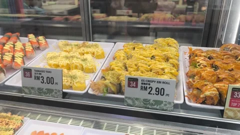 Various Types of Fresh Sushi Displayed for Sale Behind Glass Stock Footage 321040119