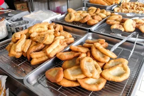 Various types of fried bread sticks or you tiao at hawker stall Stock Photos