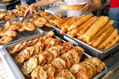 Various types of fried bread sticks or you tiao at hawker stall Stock Photos