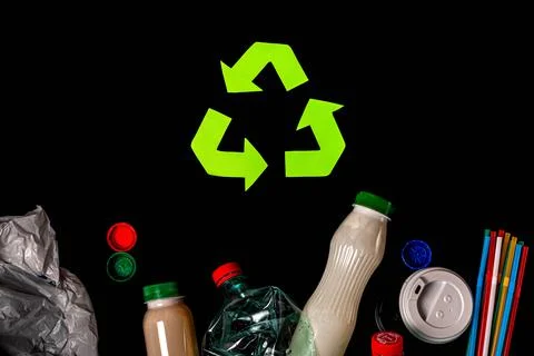 Various types of garbage and recycle sign on black Stock Photos