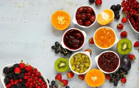 Various types of jams and preserves from different berries Stock Photos