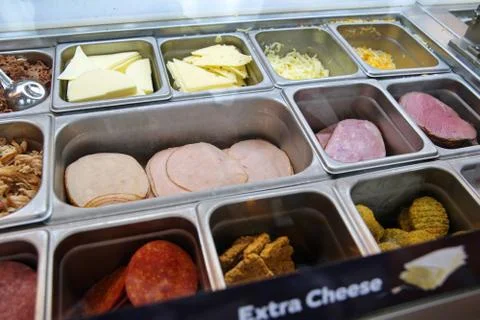 Various types of meats, cold cuts, and cheese at a sub sandwich eatery. Stock Photos