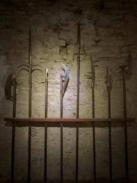 Various types of medieval spears and halberds along a stone wall Stock Photos