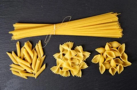 Various types of pasta on black background, from above Stock Photos
