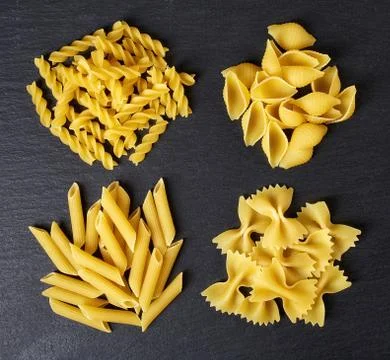 Various types of pasta on black background, from above Stock Photos