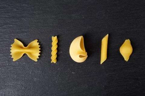 Various types of pasta on black background, from above Stock Photos