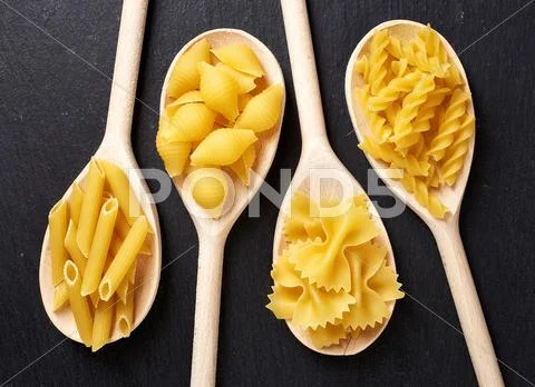 Various Types Of Pasta On Black Background, From Above