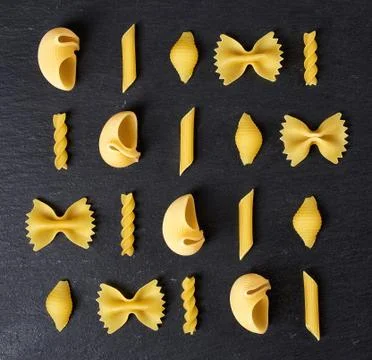 Various types of pasta on black background, from above Stock Photos