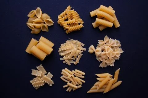 Various types of pasta on black background Stock Photos