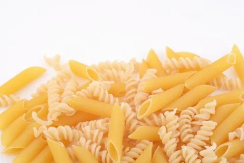 Various types of pasta on a white background. Stock Photos