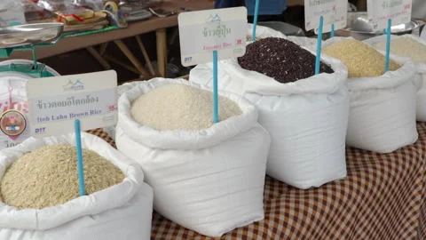 Various types of raw rices are for sale at a local farmer market Stock Footage 244111291