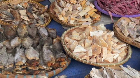 Various types of salted dried fish displayed in bamboo baskets . Stock Footage 323720437