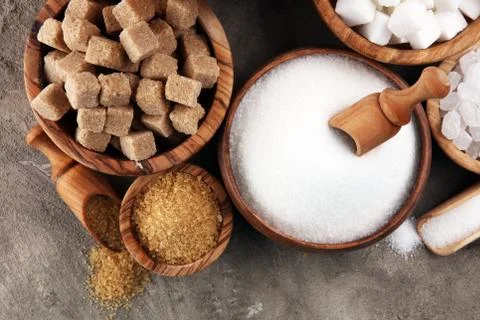 Various types of sugar, brown sugar and white on table Foto stock