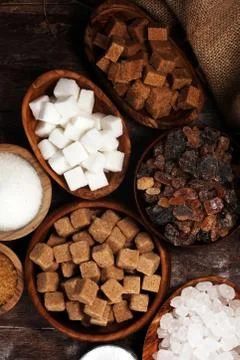 Various types of sugar, brown sugar and white on wooden table Stock Photos