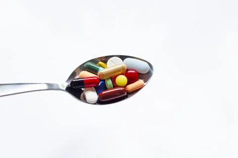 Various types of tablets, capsules and pills on  spoon Stock Photos