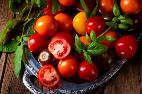 Various types of tomatoes served and presented on the silver platter. Stock Photos