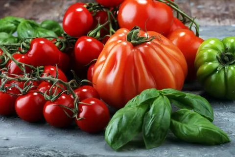 Various types of tomatoes on vintage background Stock Photos