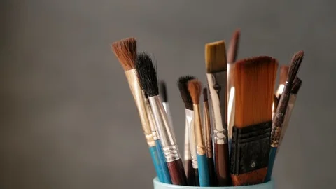 Various used paint brushes in a jar , close up. Stock Footage 86929237
