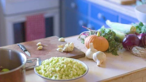 Various vegetables and ingredients on kitchen worktop Vídeos de archivo 76137185