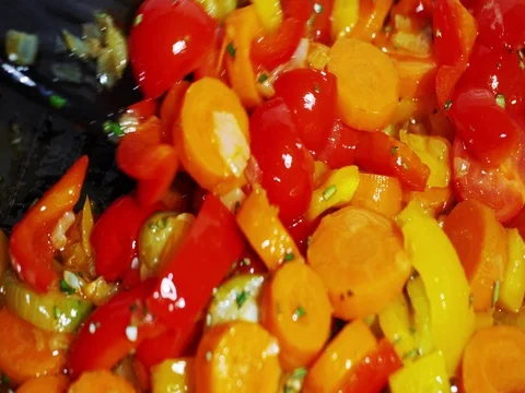 Various vegetables being fried in oil and stirred slowly, close up Stock Footage 83617277