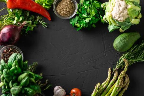 Various vegetables on a dark background. Frame. Place for text. Vegetarian ve Stock Photos