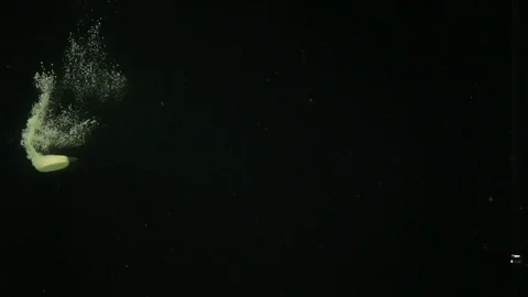 Various vegetables fall into the water creating bubbles. Stock Footage 117109320