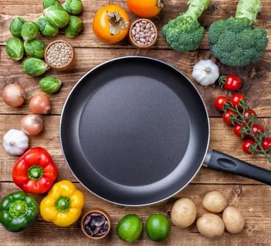 Various vegetables fruits and herbs with a frying pan Stock Photos