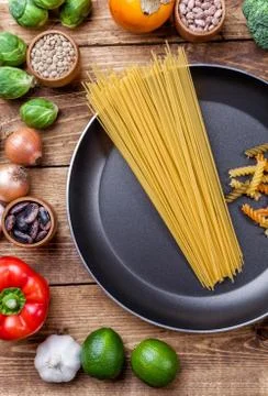 Various vegetables fruits and herbs with a frying pan Stock Photos