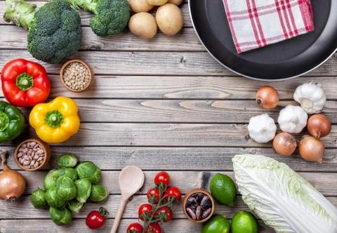 Various vegetables fruits and herbs with a frying pan Stock Photos