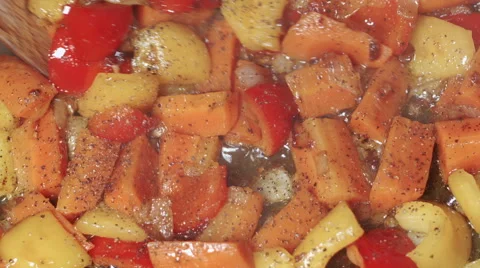 Various vegetables with pepper being fried in oil and stirred, close up Stock Footage 45417082