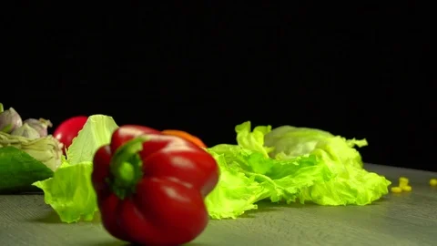 Various vegetables shot on a black background. Turn. Are falling. Stock Footage 117105334