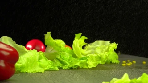 Various vegetables shot on a black background. Turn. Are falling. Stock Footage 117105436