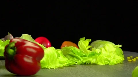 Various vegetables shot on a black background. Turn. Are falling. Stock Footage 117105600