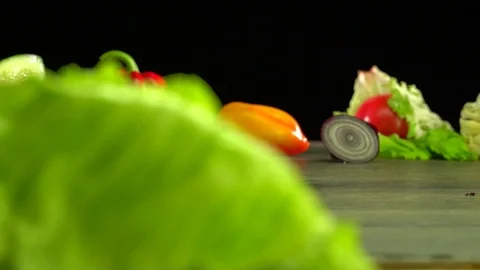 Various vegetables shot on a black background. Turn. Are falling. Stock Footage 117105774