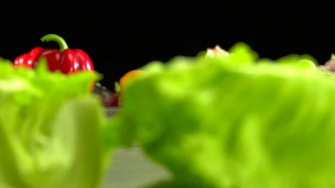 Various vegetables shot on a black background. Turn. Are falling. Stock Footage 117106311