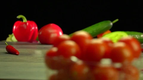 Various vegetables shot on a black background. Turn. Are falling. Stock Footage 117106408