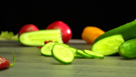 Various vegetables shot on a black background. Turn. Are falling. Stock Footage 117106582