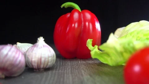 Various vegetables shot on a black background. Turn. Are falling. Stock Footage 117107660