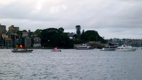 Various vessels including Aboriginal flag boat in Sydney Harbour 4K Stock Footage 330583489