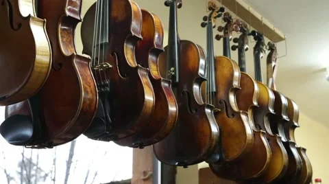 Various violins hanging in workshop Stock-Footage 47747344