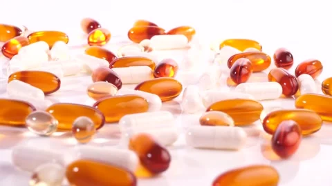 Various white and orange Capsules  - Healthy Nutrition Pills Stock Footage 221643637