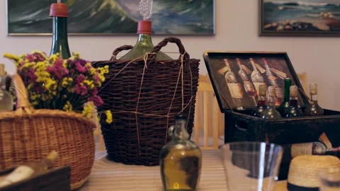 Various Wine Bottles. Large Fermentation Bottle in Wicker Basket Stock Footage 267482396